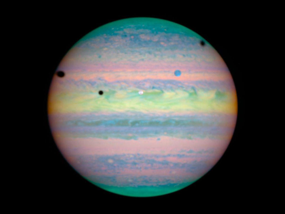 Moons castng shadows on Jupiter by NASA/ESA